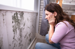 Women looking at mold damage in her home